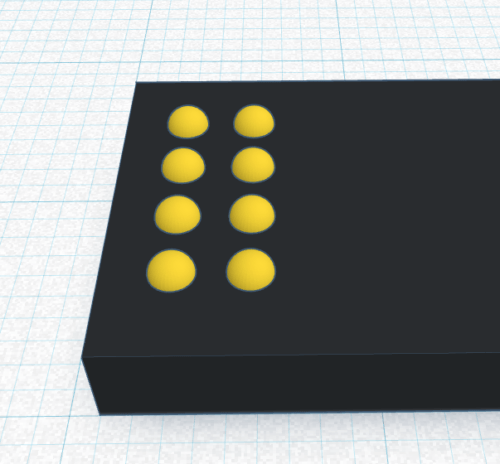 A Braille cell is placed on the cuboid